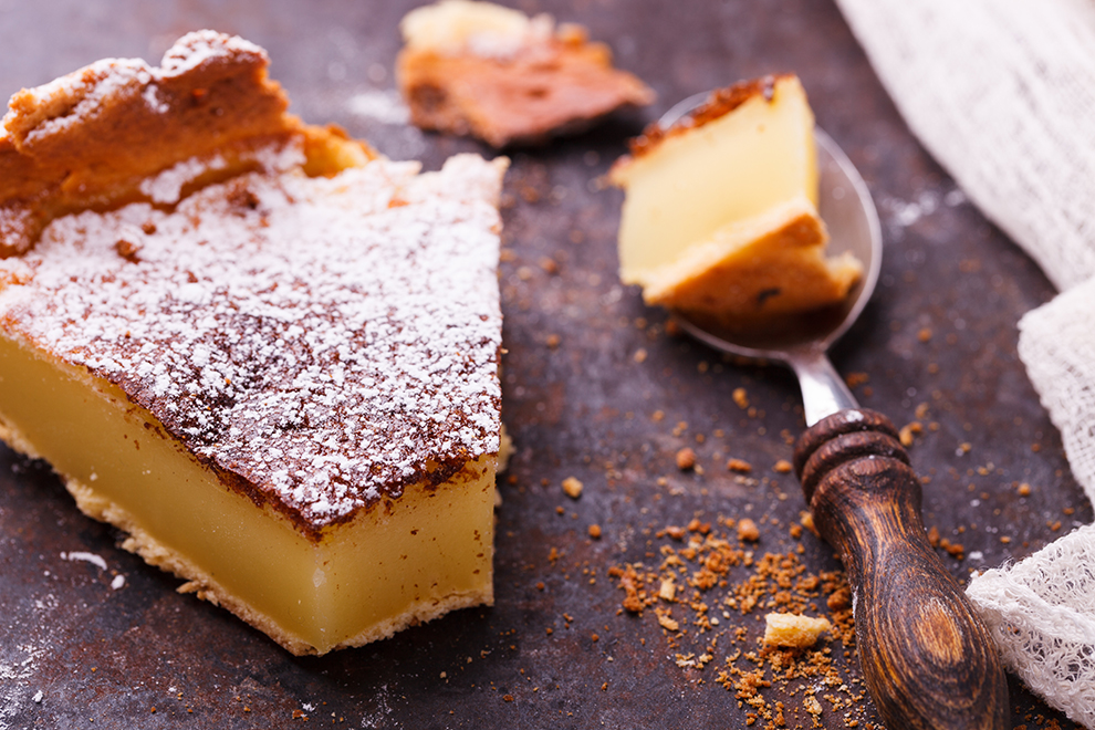 Flan at home, sprinkled with powdered sugar.selective focus